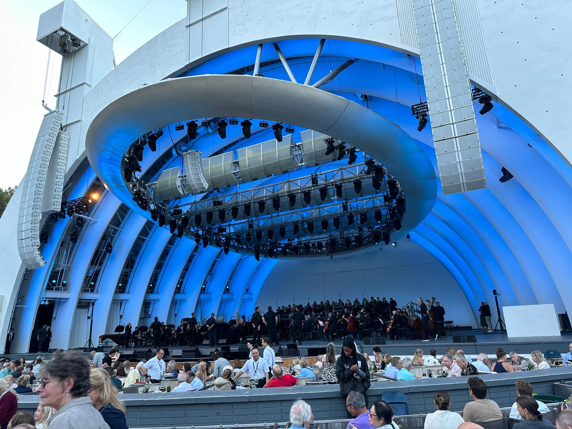 The Hollywood Bowl lit in blue, with the orchestra and choir on stage